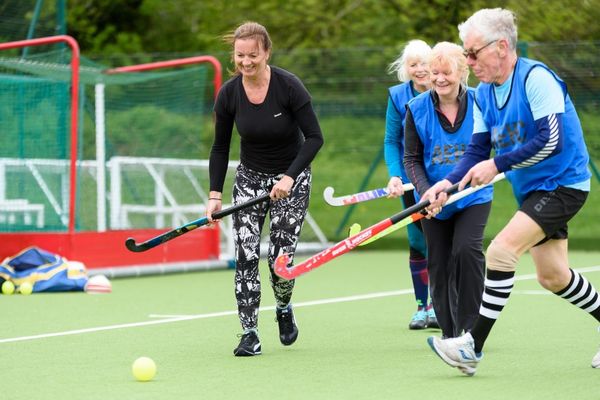 Adults playing hockey